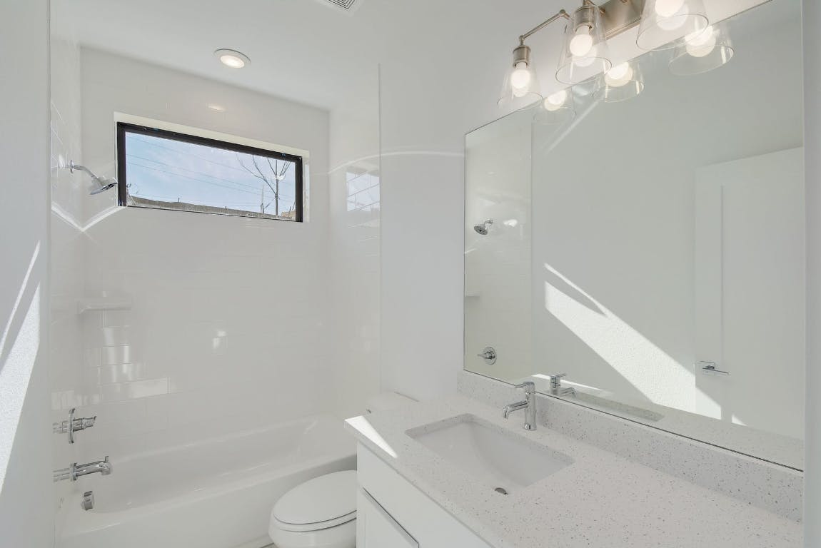 2050 Lohmans Spur Road, Unit 402 Austin, TX 78734 - Photo 27 of 39 a bathroom with a sink a toilet and shower