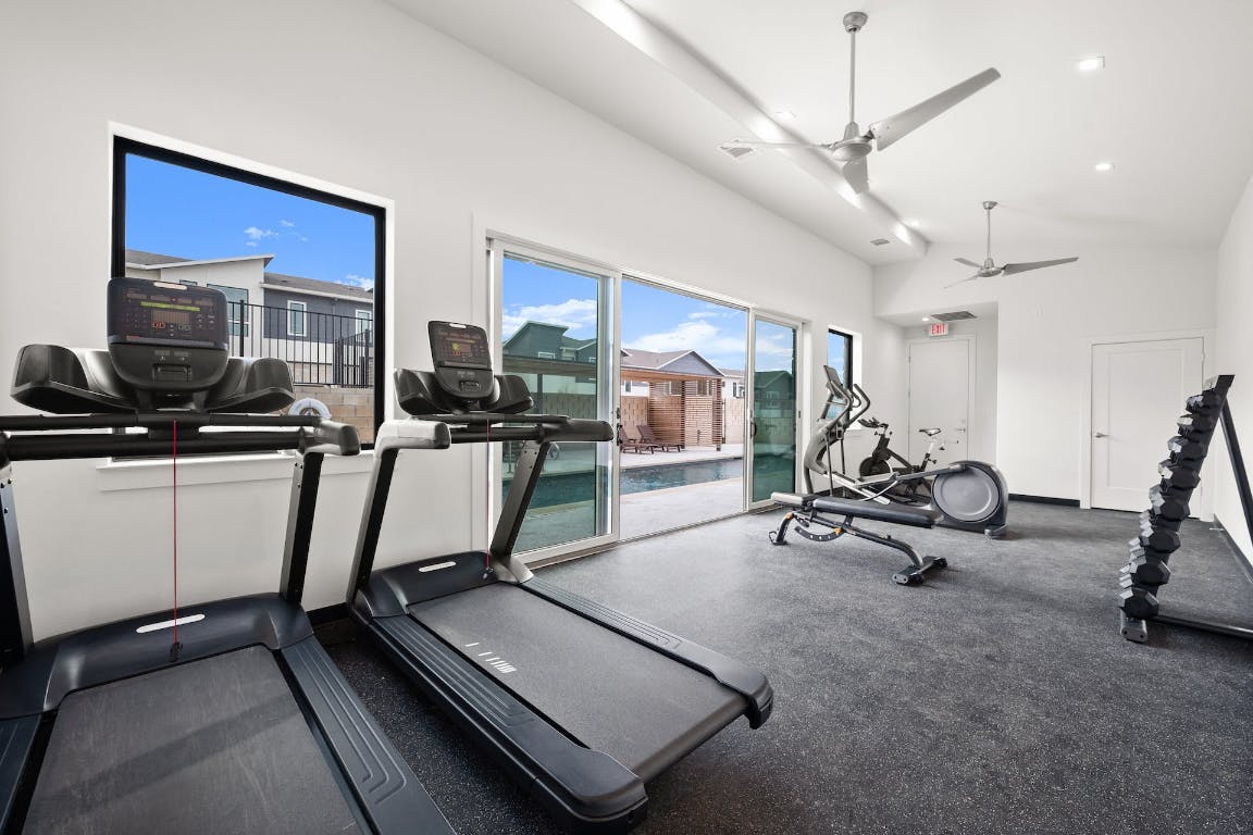 2050 Lohmans Spur Road, Unit 402 Austin, TX 78734 - Photo 36 of 39 a room with gym equipment and windows