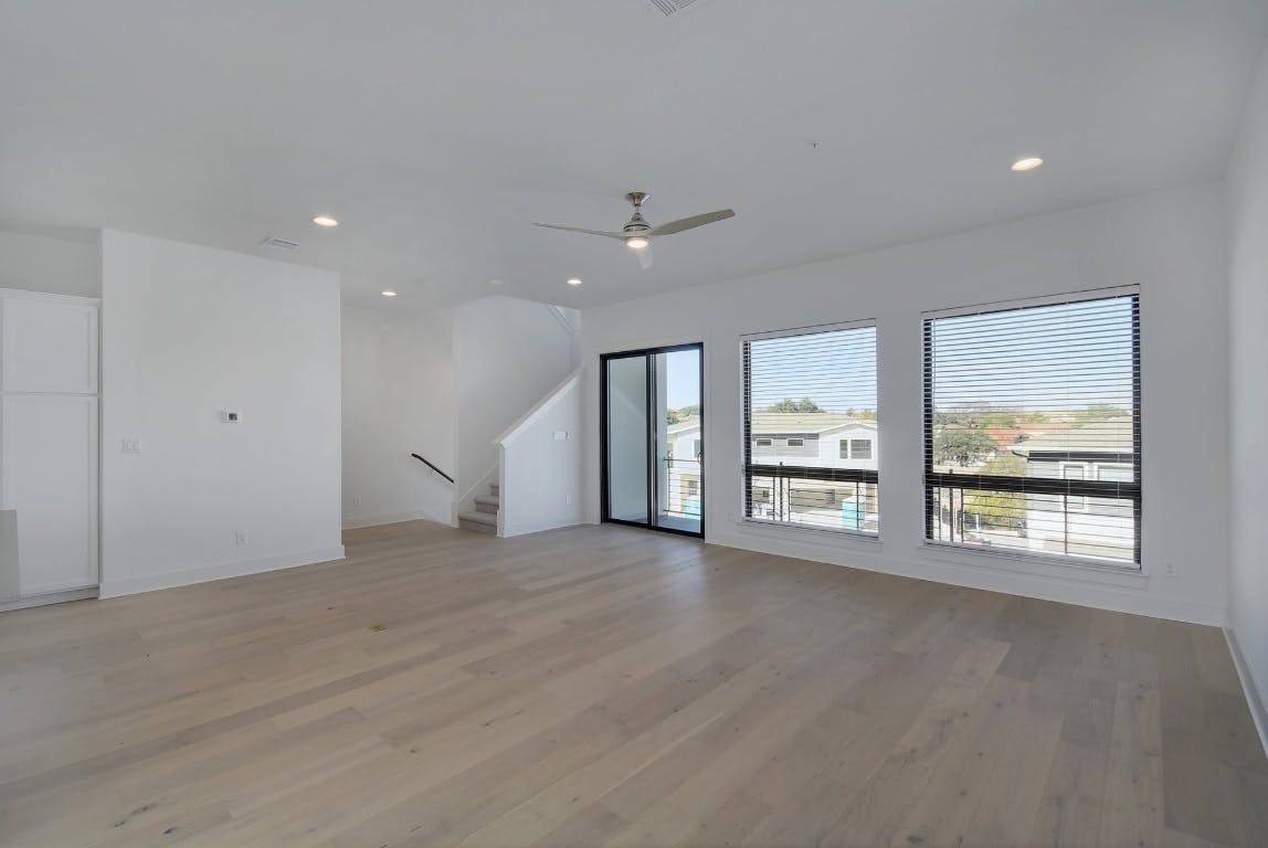 2050 Lohmans Spur Road, Unit 402 Austin, TX 78734 - Photo 4 of 39 an empty room with windows and cabinet