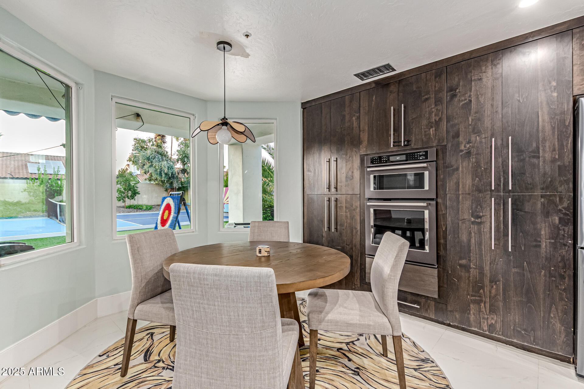 12528 North 78th Street Scottsdale, AZ 85260 - Photo 14 of 62 a kitchen with stainless steel appliances a refrigerator a sink a dining table and chairs