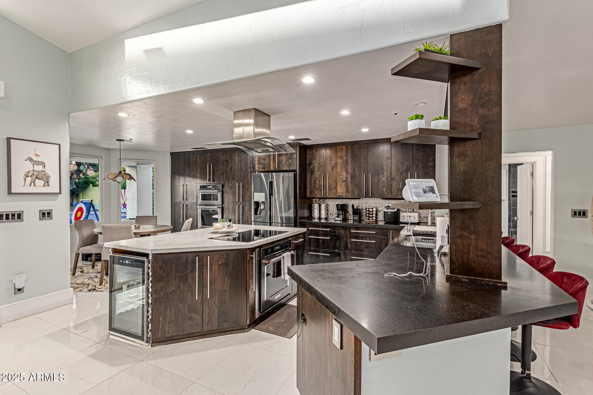 12528 North 78th Street Scottsdale, AZ 85260 - Photo 15 of 62 a kitchen with a sink a stove and chairs