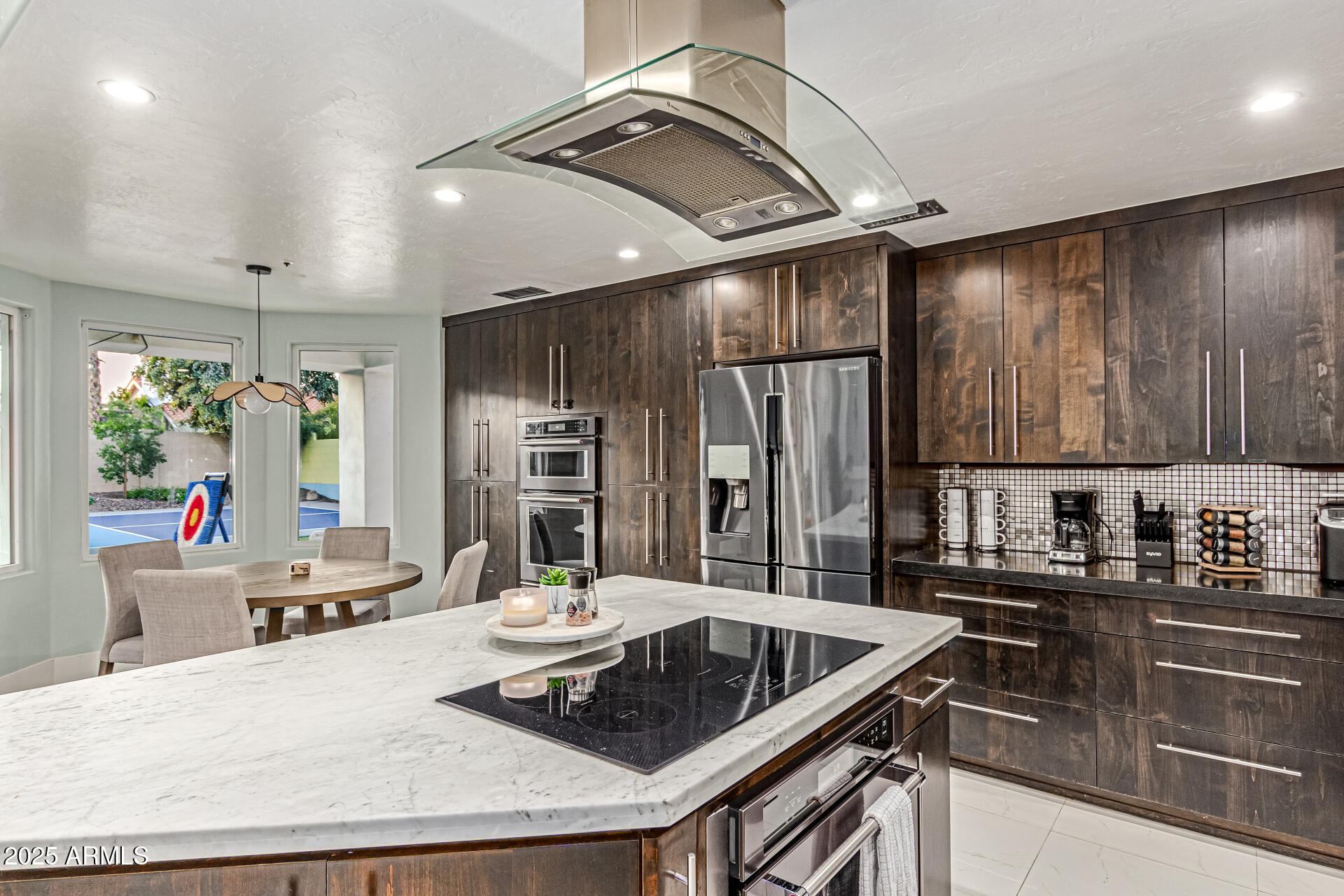 12528 North 78th Street Scottsdale, AZ 85260 - Photo 18 of 62 a kitchen with stainless steel appliances kitchen island granite countertop a sink and cabinets