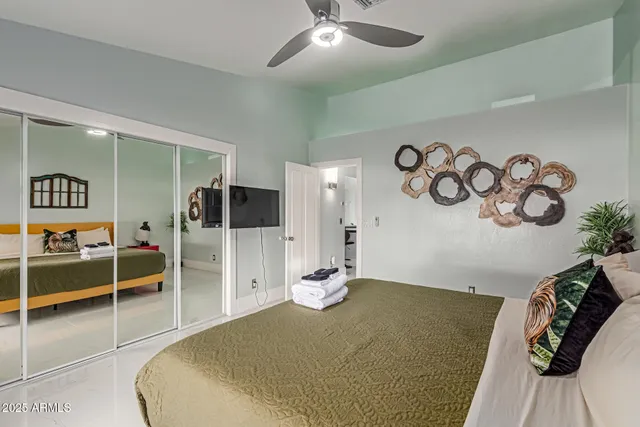 a living room with furniture pool table wooden floor and windows