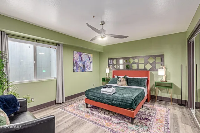 a living room with furniture and a floor to ceiling window