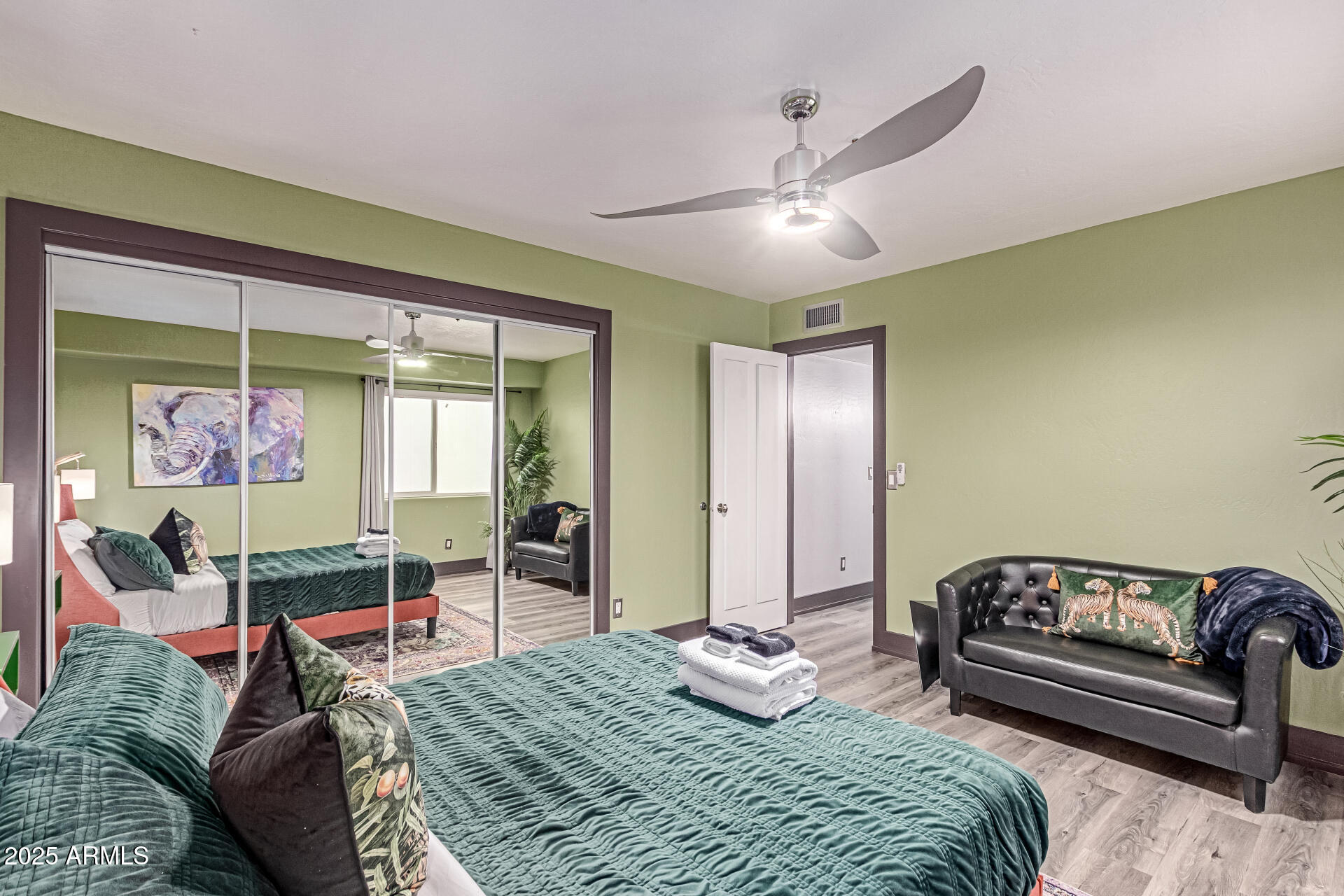 12528 North 78th Street Scottsdale, AZ 85260 - Photo 47 of 62 a bedroom with a bed and wooden floor