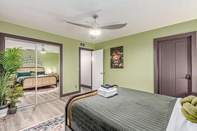 a view of a tennis ground with large trees