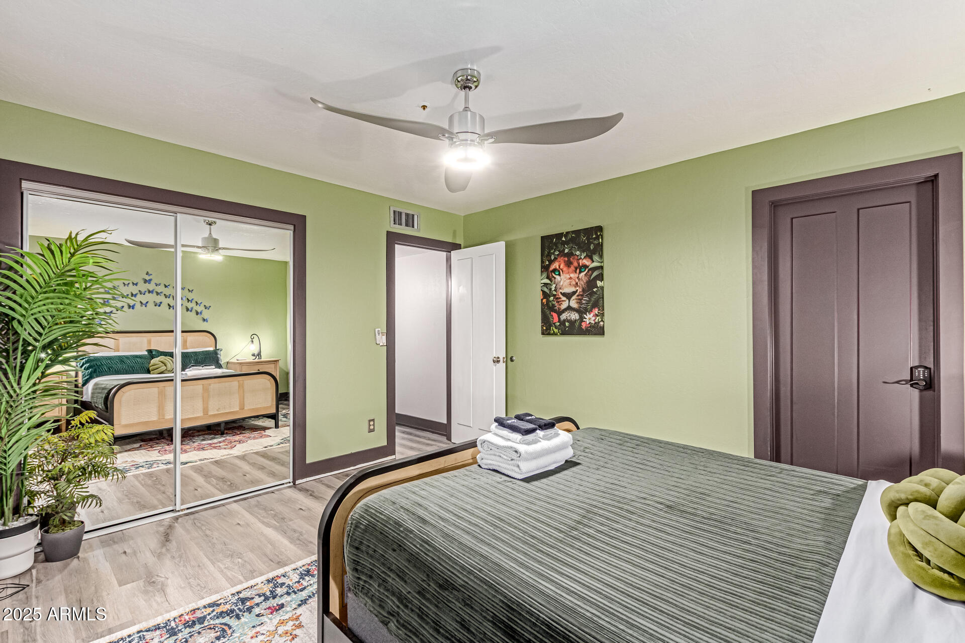 12528 North 78th Street Scottsdale, AZ 85260 - Photo 49 of 62 a bedroom with a large bed and a potted plant