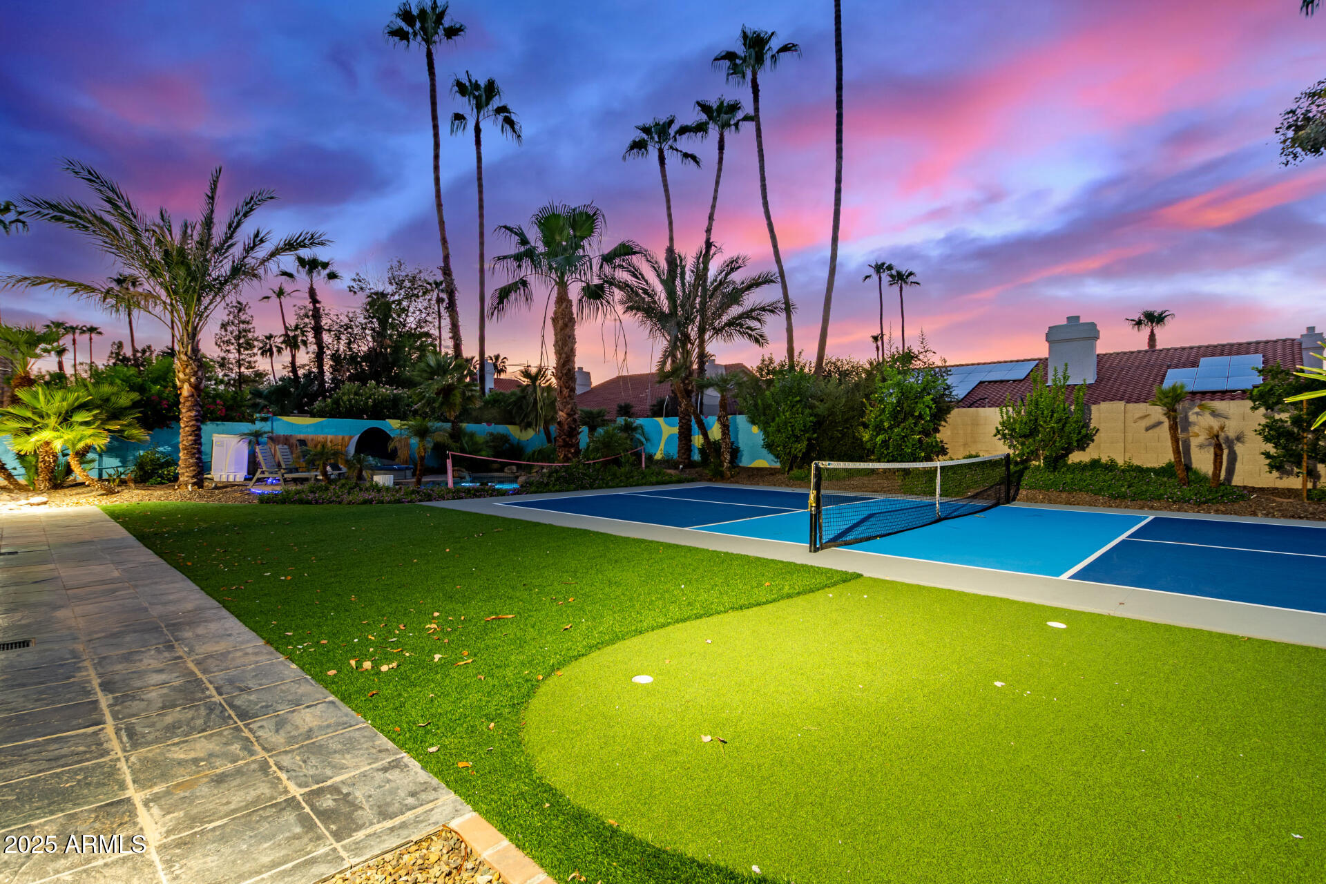 12528 North 78th Street Scottsdale, AZ 85260 - Photo 52 of 62 a view of a swimming pool with a lawn chairs and palm trees