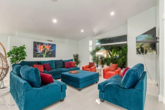 a view of a dining room with furniture a chandelier and a large window
