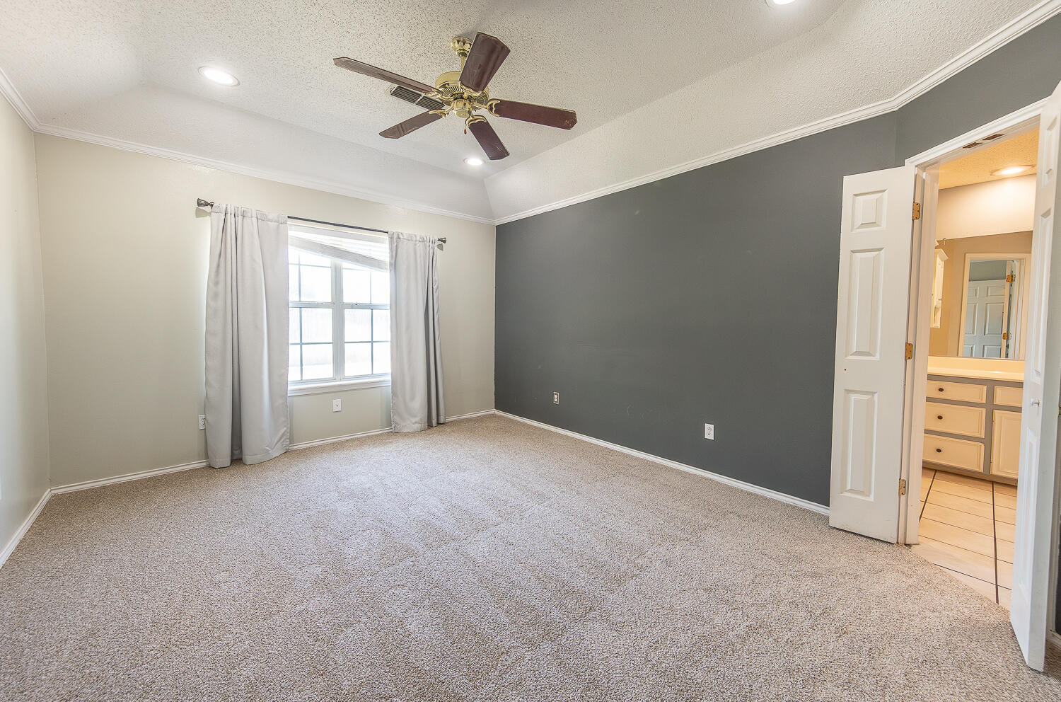 2923 85th Street Lubbock, TX 79423 - Photo 13 of 23 an empty room with windows and ceiling fan