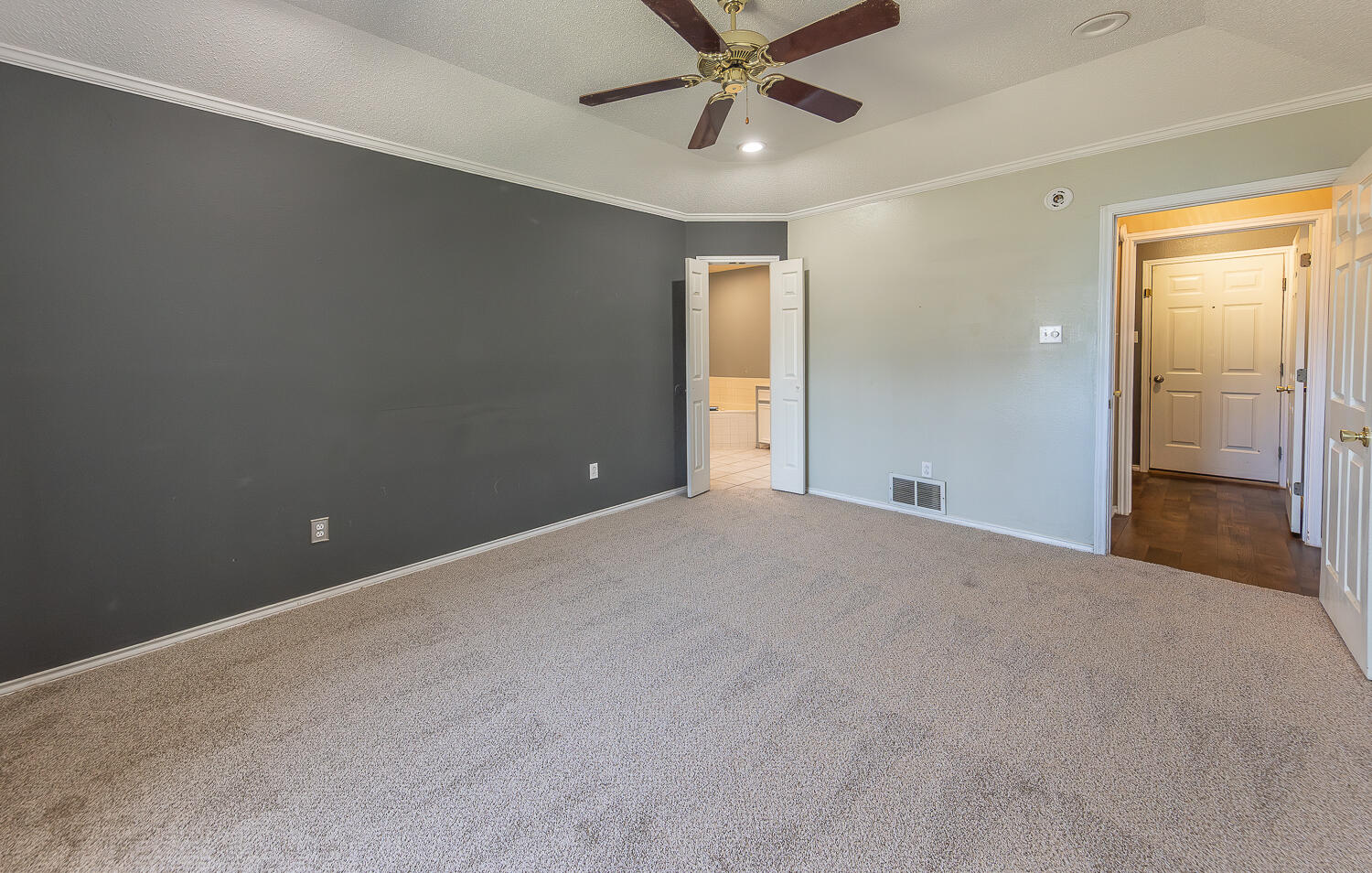 2923 85th Street Lubbock, TX 79423 - Photo 14 of 23 a view of a big room with wooden floor and windows in a room
