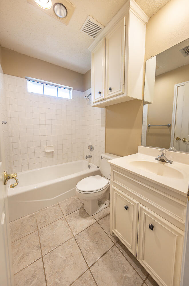 2923 85th Street Lubbock, TX 79423 - Photo 21 of 23 a bathroom with a sink a toilet and a bathtub