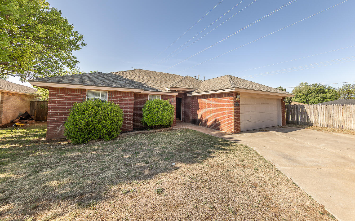 2923 85th Street Lubbock, TX 79423 - Photo 23 of 23 a front view of a house with a yard and garage