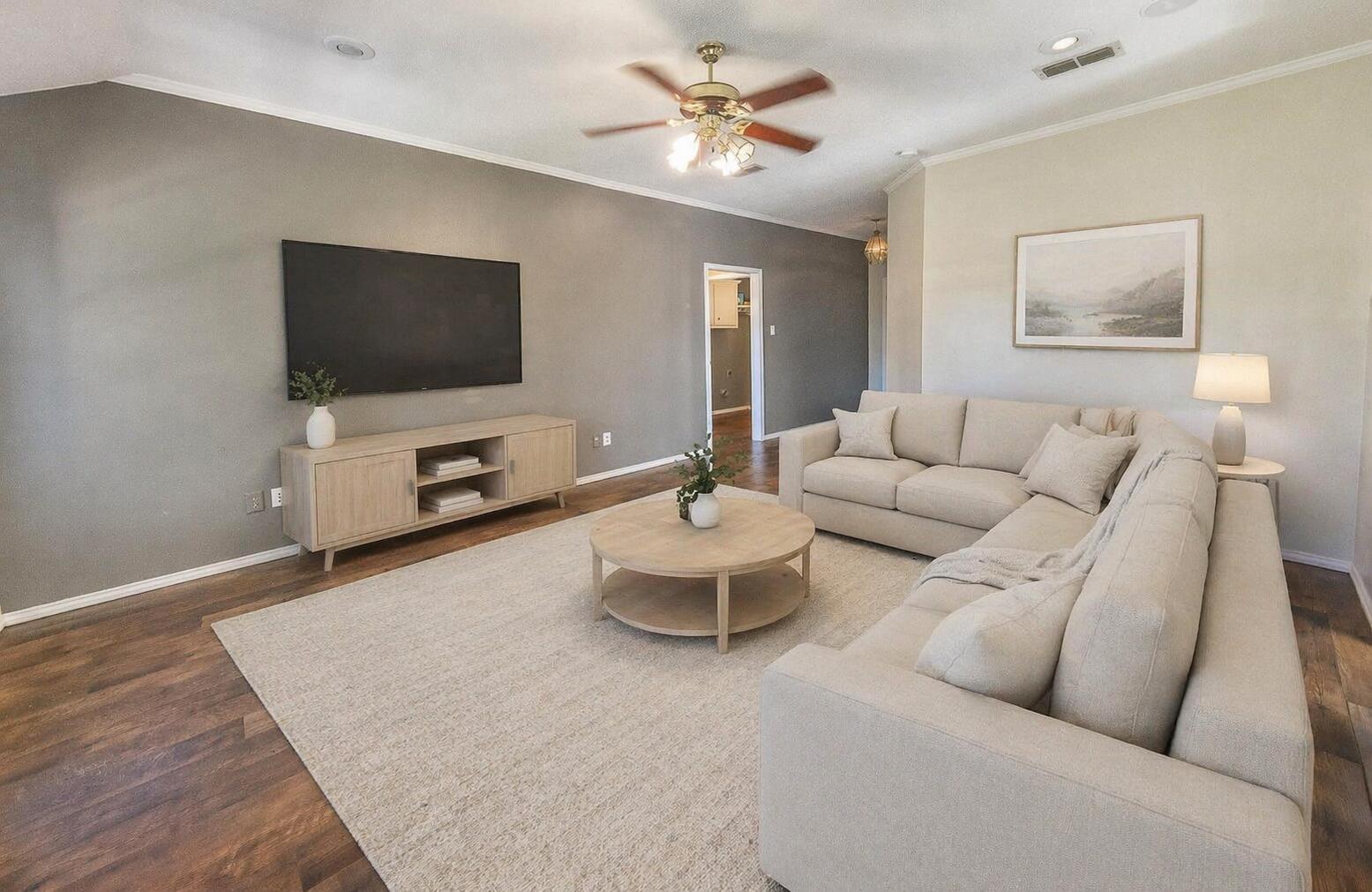2923 85th Street Lubbock, TX 79423 - Photo 4 of 23 a living room with furniture and a flat screen tv