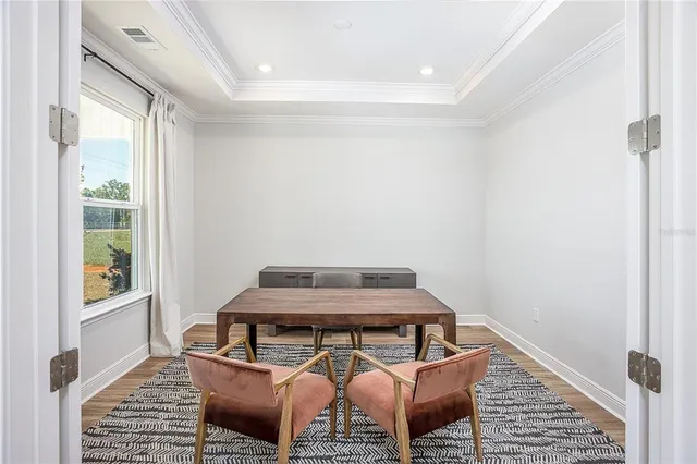 a view of a room with wooden floor and windows