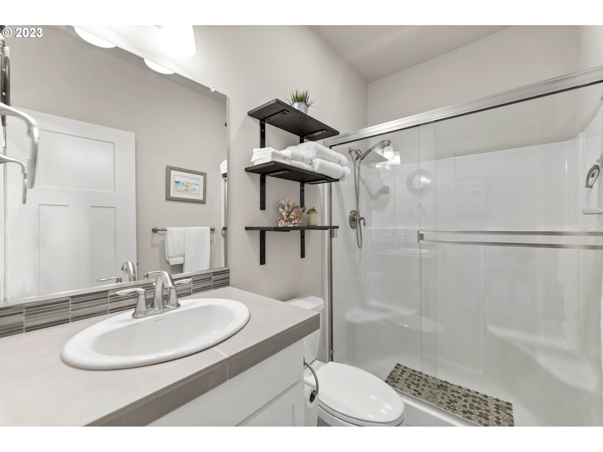 1851 South 47th Place Ridgefield, WA 98642 - Photo 14 of 31 a bathroom with a sink toilet double vanity and shower
