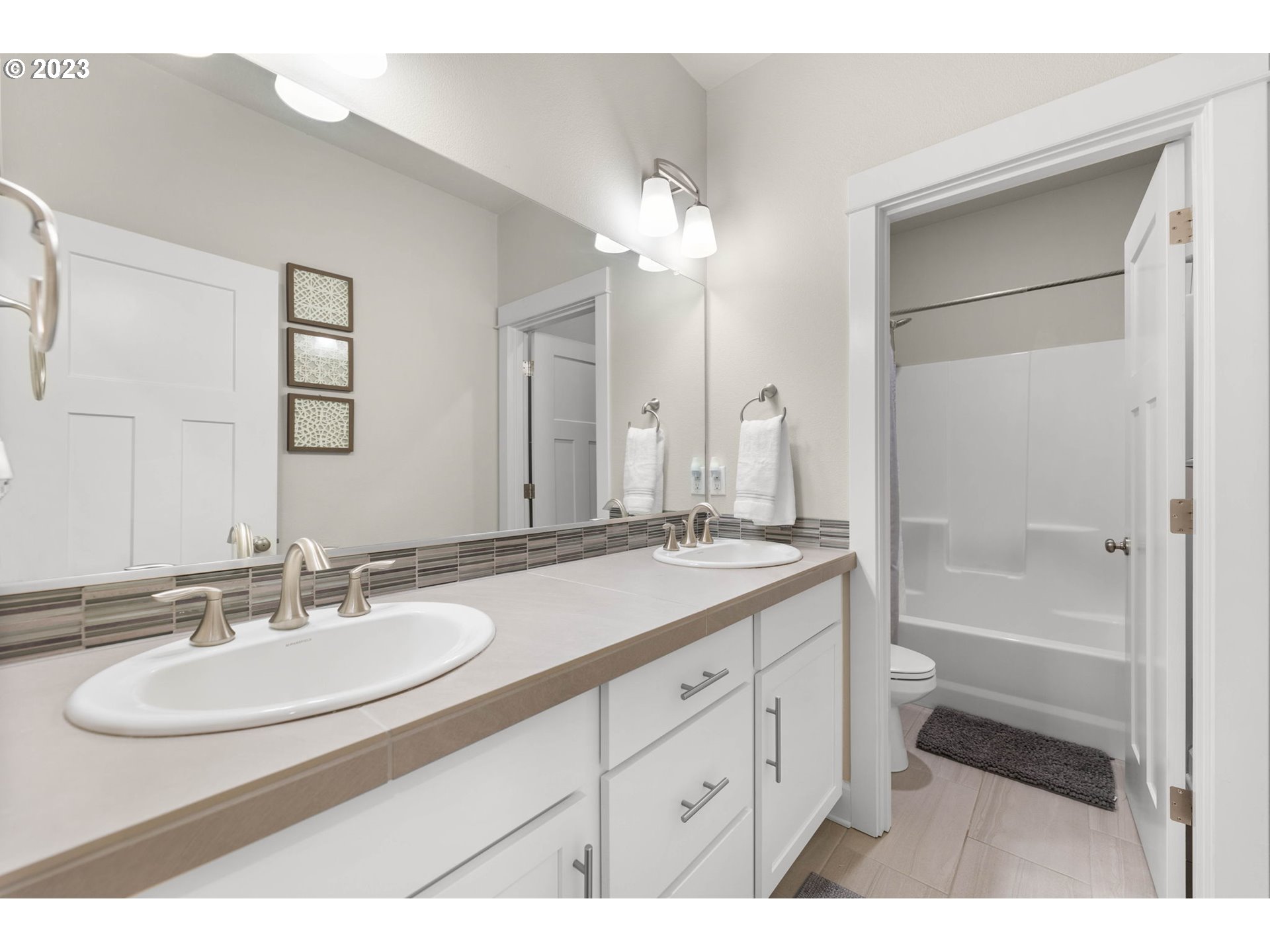 1851 South 47th Place Ridgefield, WA 98642 - Photo 24 of 31 a bathroom with a sink double vanity granite tub and a mirror