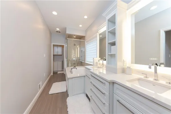 a bathroom with a sink a toilet a mirror and vanity