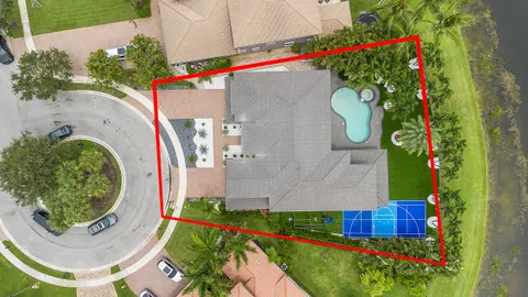 a aerial view of a house with a yard and garden