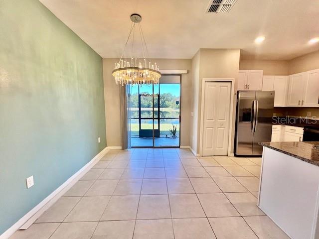 8606 Reedville Street New Port Richey, FL 34654 - Photo 14 of 85 a open kitchen with stainless steel appliances a refrigerator and a stove top oven