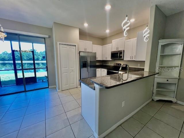 8606 Reedville Street New Port Richey, FL 34654 - Photo 16 of 85 a kitchen with stainless steel appliances granite countertop a sink and a stove top oven
