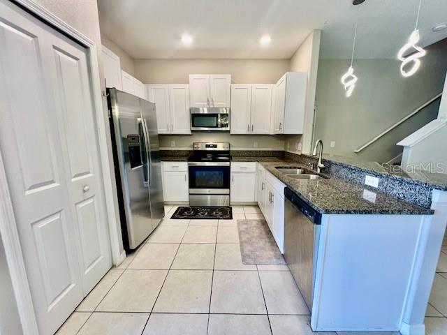 8606 Reedville Street New Port Richey, FL 34654 - Photo 17 of 85 a kitchen with stainless steel appliances granite countertop a refrigerator and a stove
