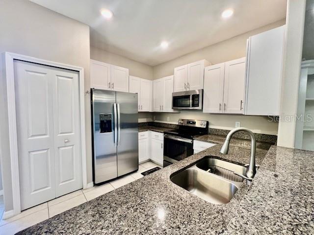 8606 Reedville Street New Port Richey, FL 34654 - Photo 18 of 85 a kitchen with stainless steel appliances granite countertop a refrigerator a stove a sink and a granite counter tops