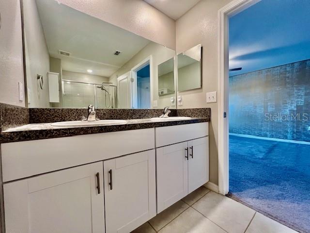 8606 Reedville Street New Port Richey, FL 34654 - Photo 31 of 85 a bathroom with a double vanity sink and mirror