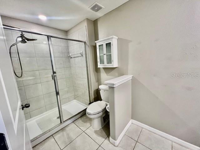 8606 Reedville Street New Port Richey, FL 34654 - Photo 34 of 85 a bathroom with a toilet and a shower