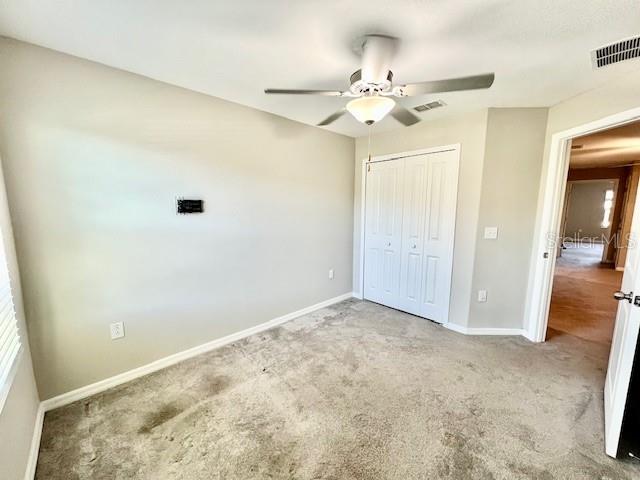 8606 Reedville Street New Port Richey, FL 34654 - Photo 44 of 85 en empty room with wooden floor and fan