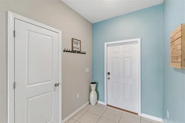 a view of a dining room with furniture a chandelier and wooden floor