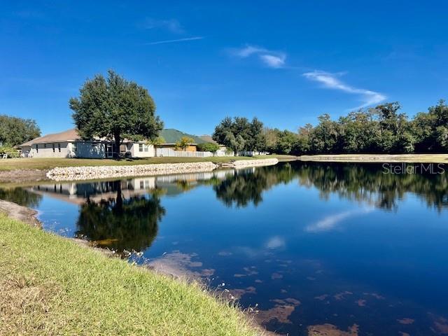 8606 Reedville Street New Port Richey, FL 34654 - Photo 58 of 85 a view of a lake in between two chairs