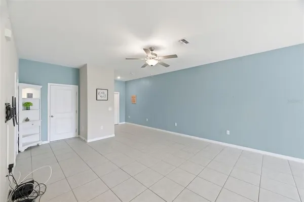 a living room with furniture pool table and windows