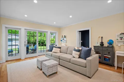 a living room with furniture and a dresser