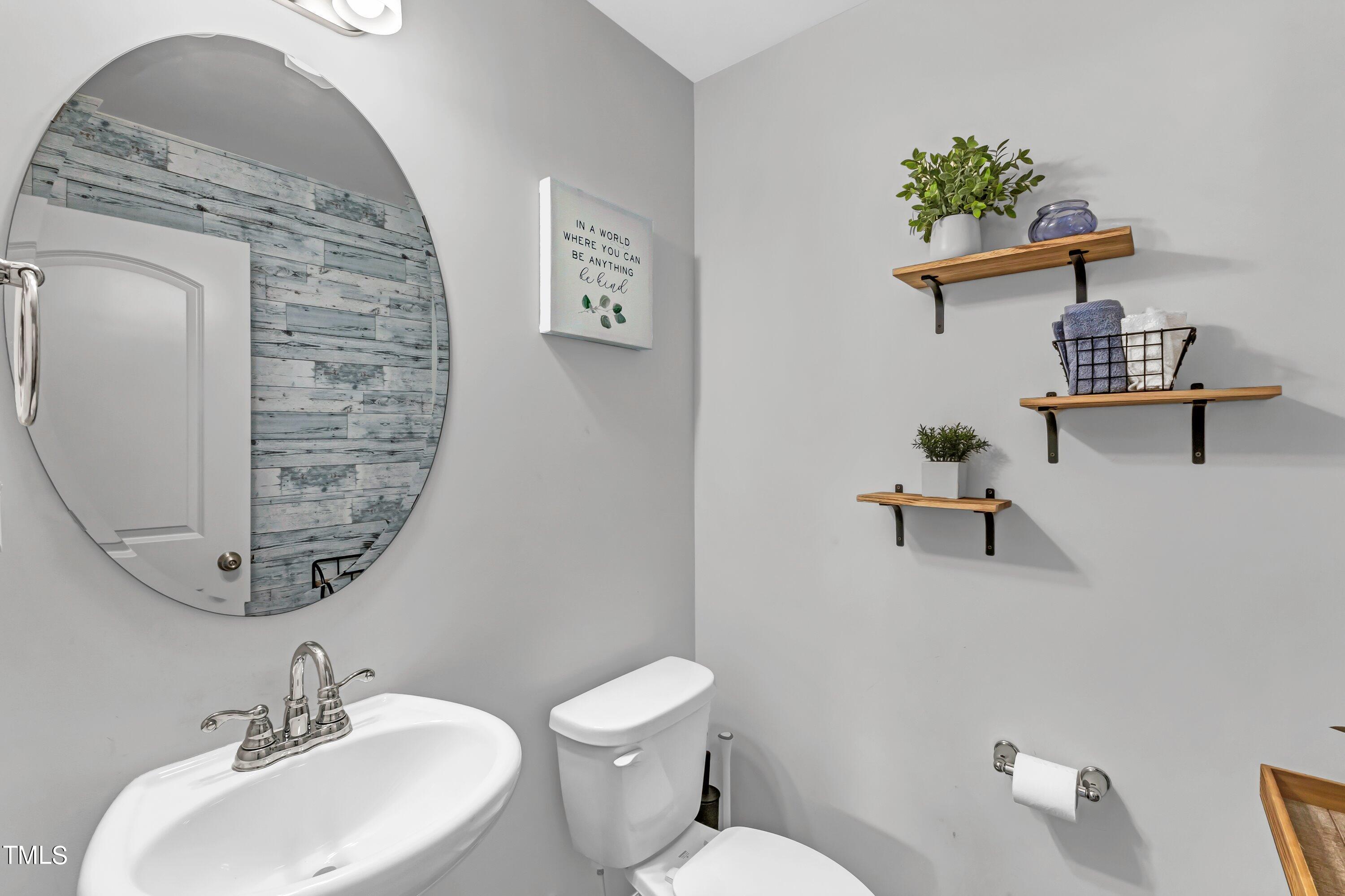 301 Connect Drive Wendell, NC 27591 - Photo 15 of 28 a bathroom with a toilet sink and mirror