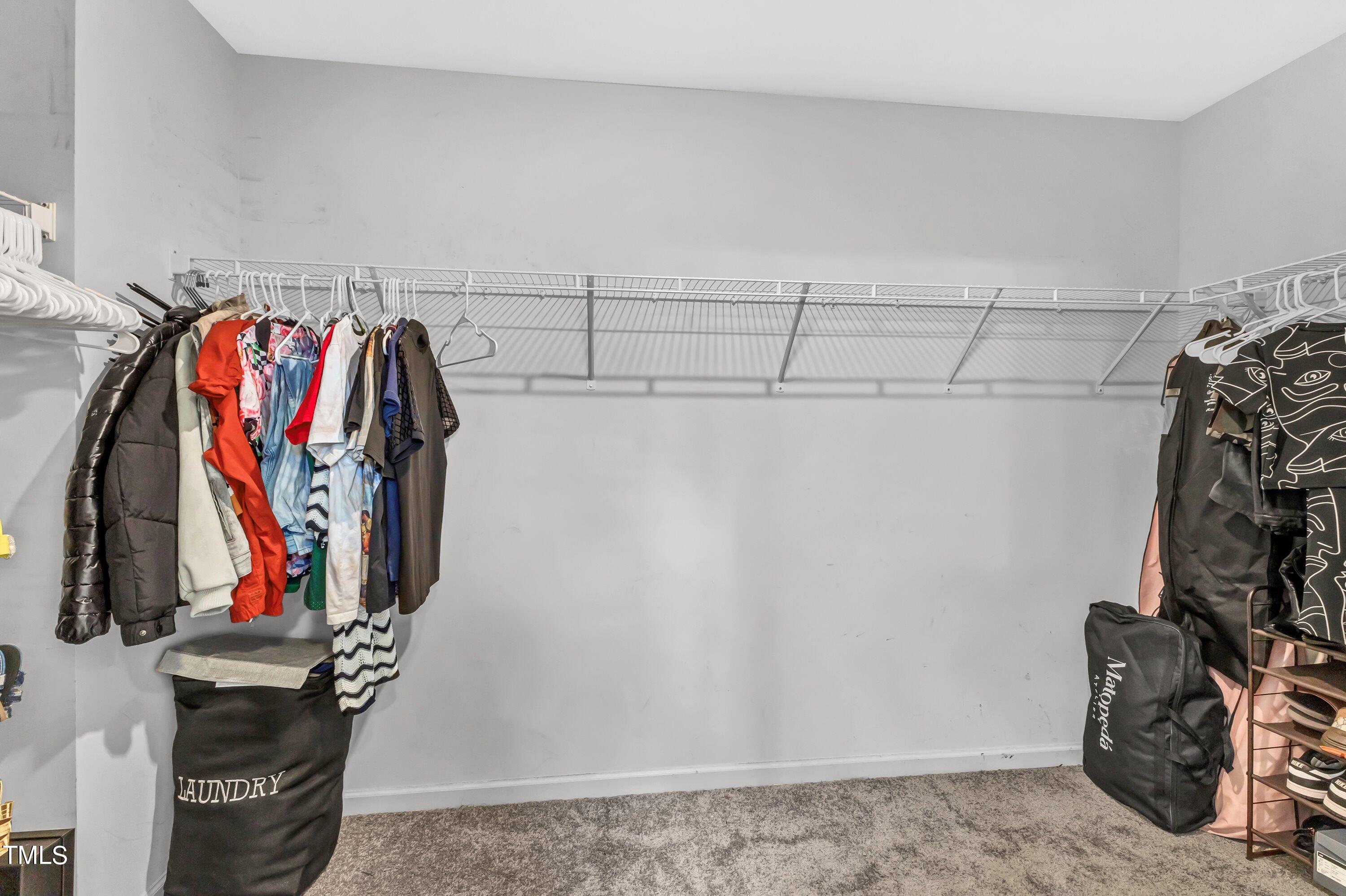 301 Connect Drive Wendell, NC 27591 - Photo 19 of 28 a view of walk in closet with clothes