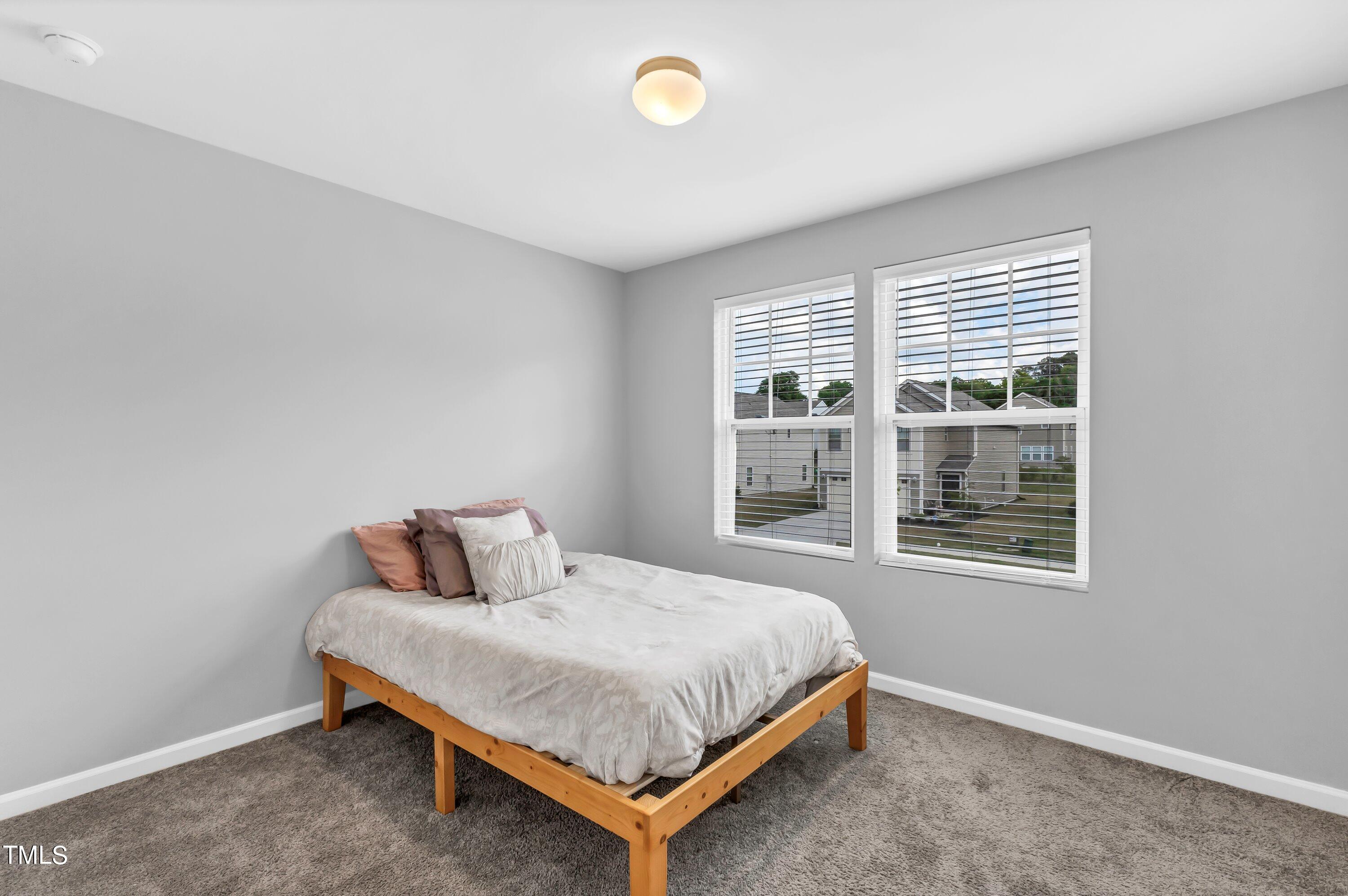 301 Connect Drive Wendell, NC 27591 - Photo 21 of 28 a bedroom with a bed and window