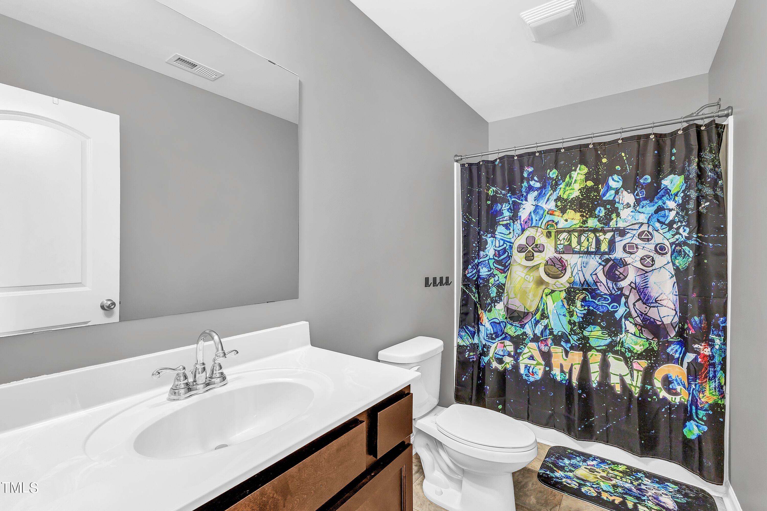301 Connect Drive Wendell, NC 27591 - Photo 24 of 28 a bathroom with a sink mirror vanity and toilet