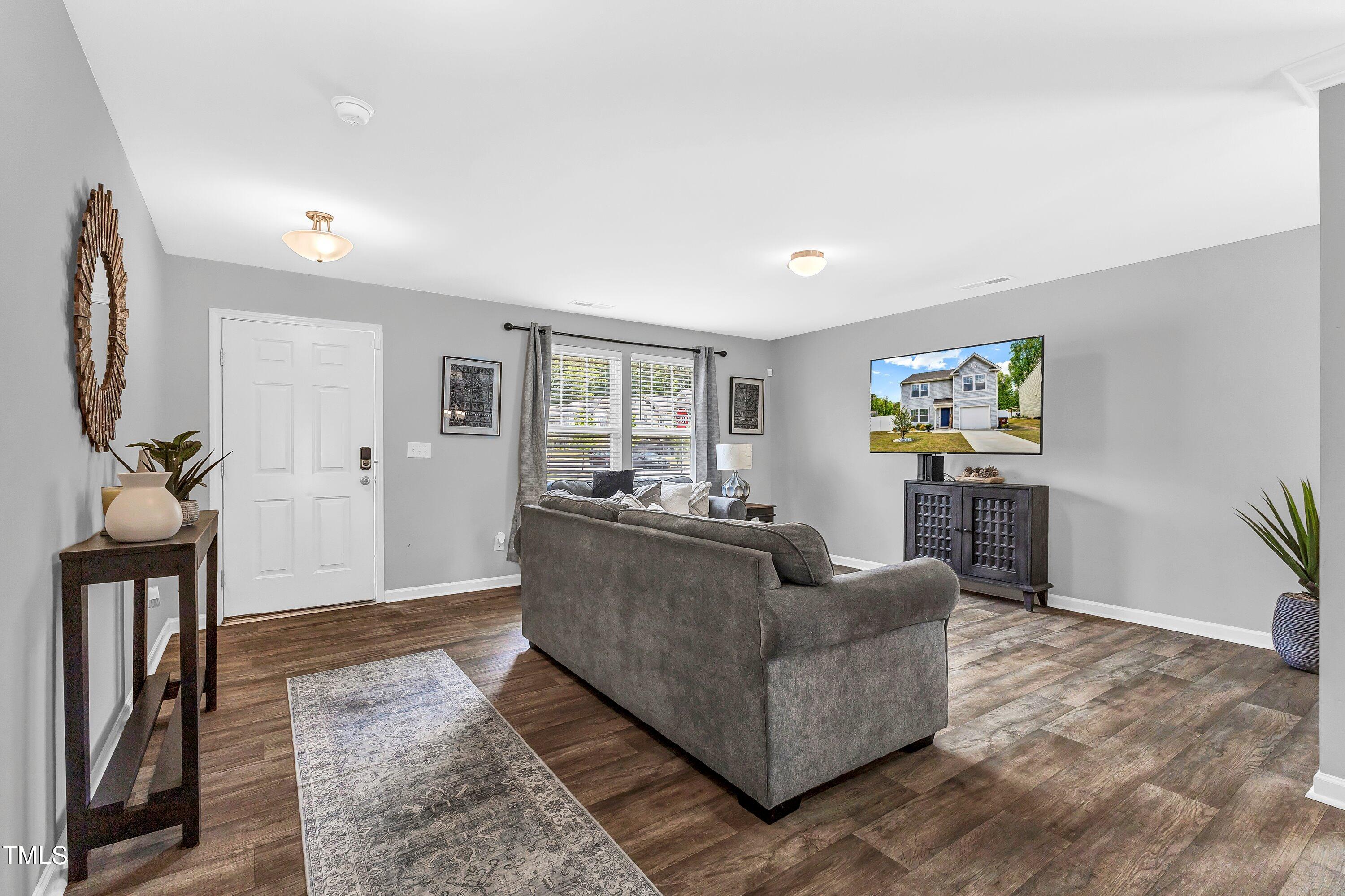 301 Connect Drive Wendell, NC 27591 - Photo 4 of 28 a living room with furniture and a wooden floor