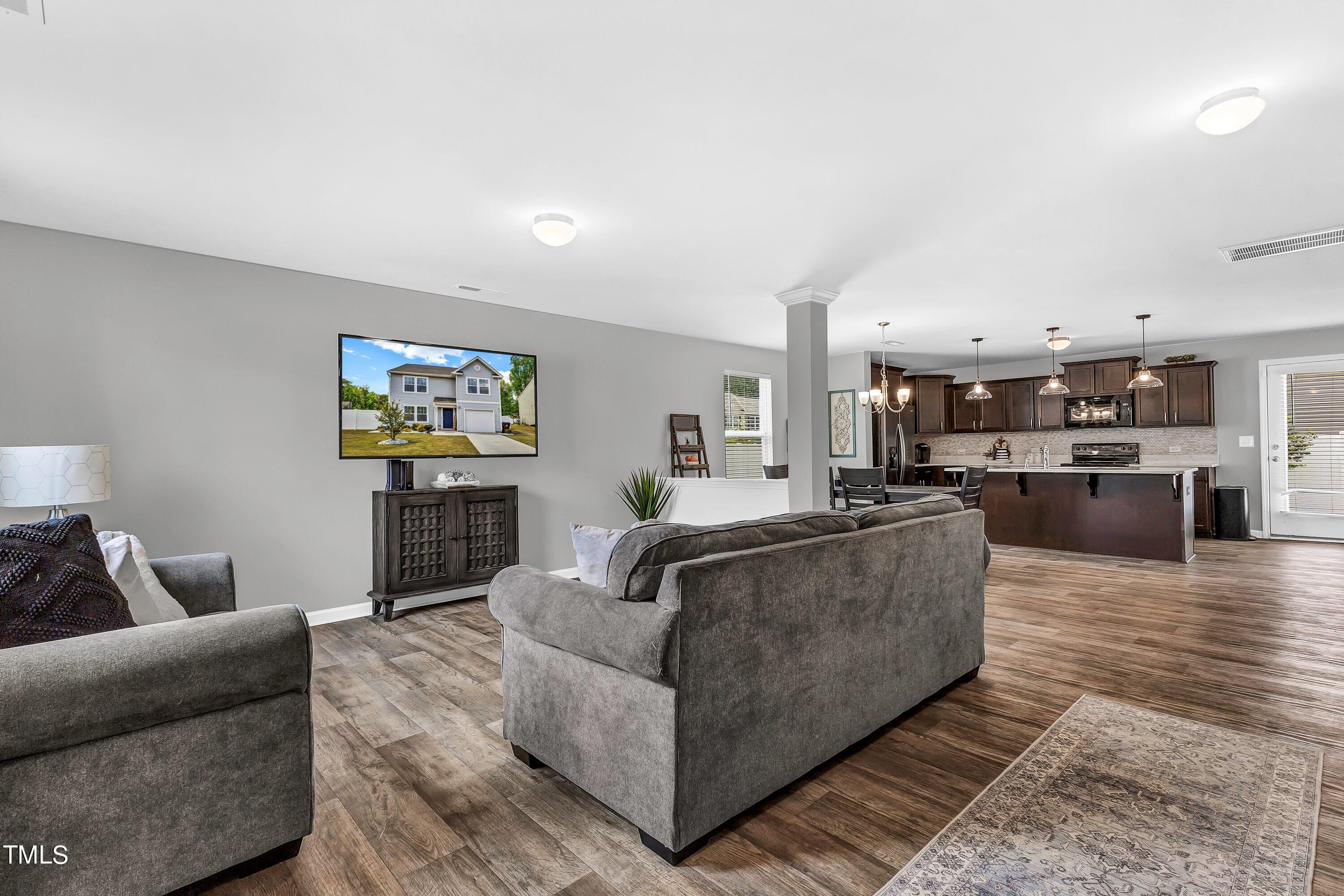 301 Connect Drive Wendell, NC 27591 - Photo 5 of 28 a living room with furniture and a flat screen tv