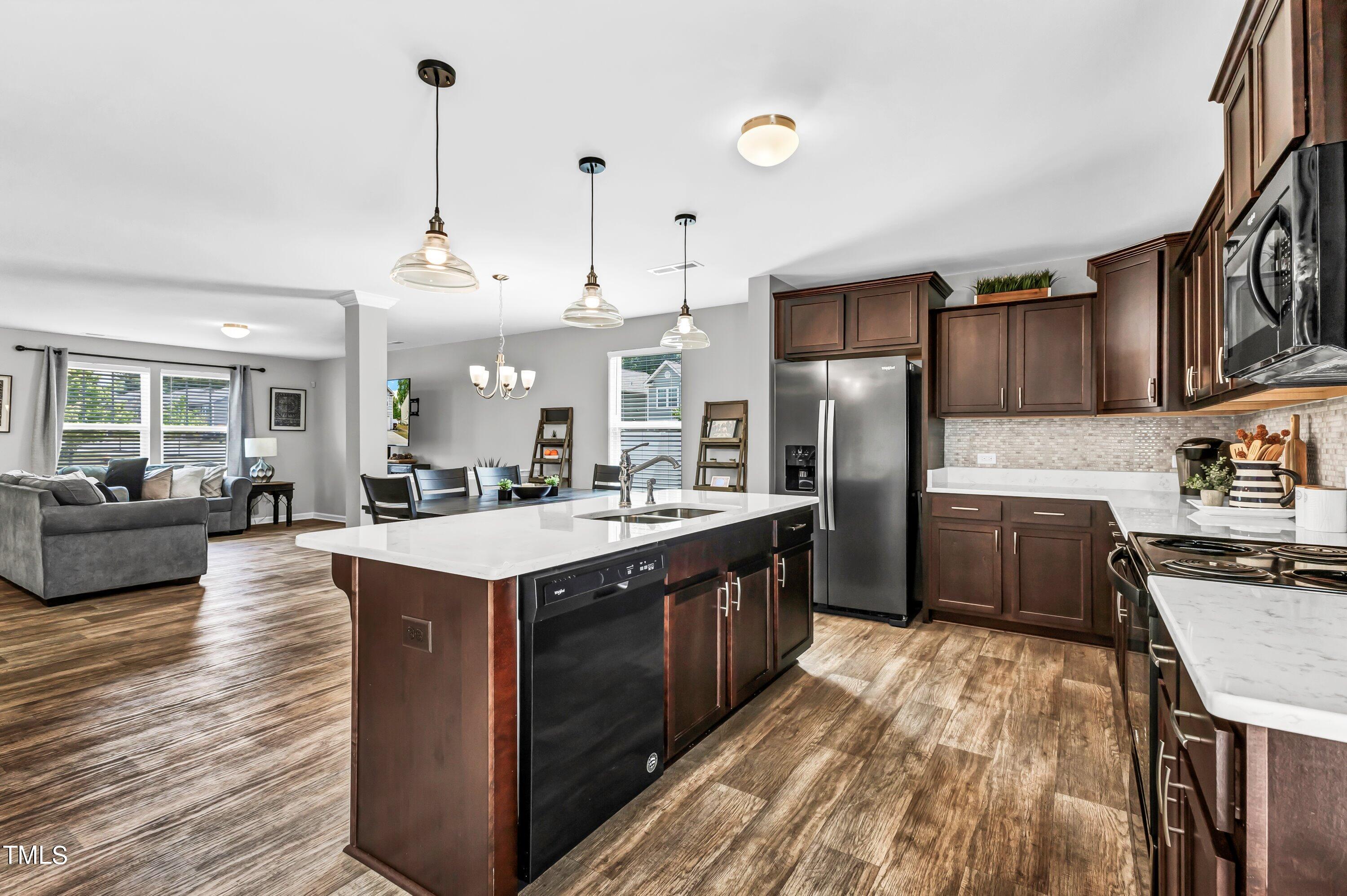 301 Connect Drive Wendell, NC 27591 - Photo 10 of 28 a kitchen with stainless steel appliances granite countertop a stove a sink dishwasher a refrigerator and a oven with wooden floor