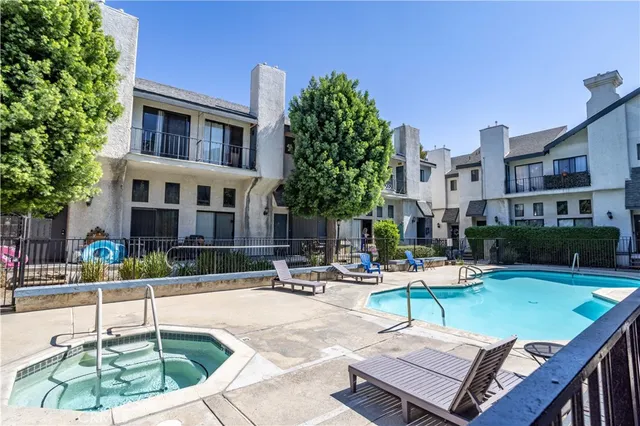 a swimming pool with outdoor seating and yard
