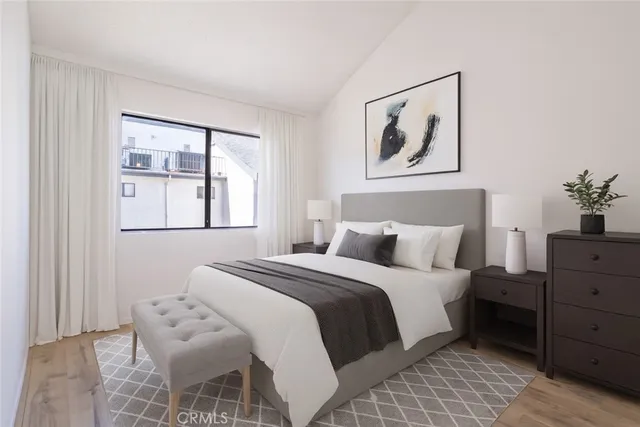 a bedroom with a bed and a painting on the wall