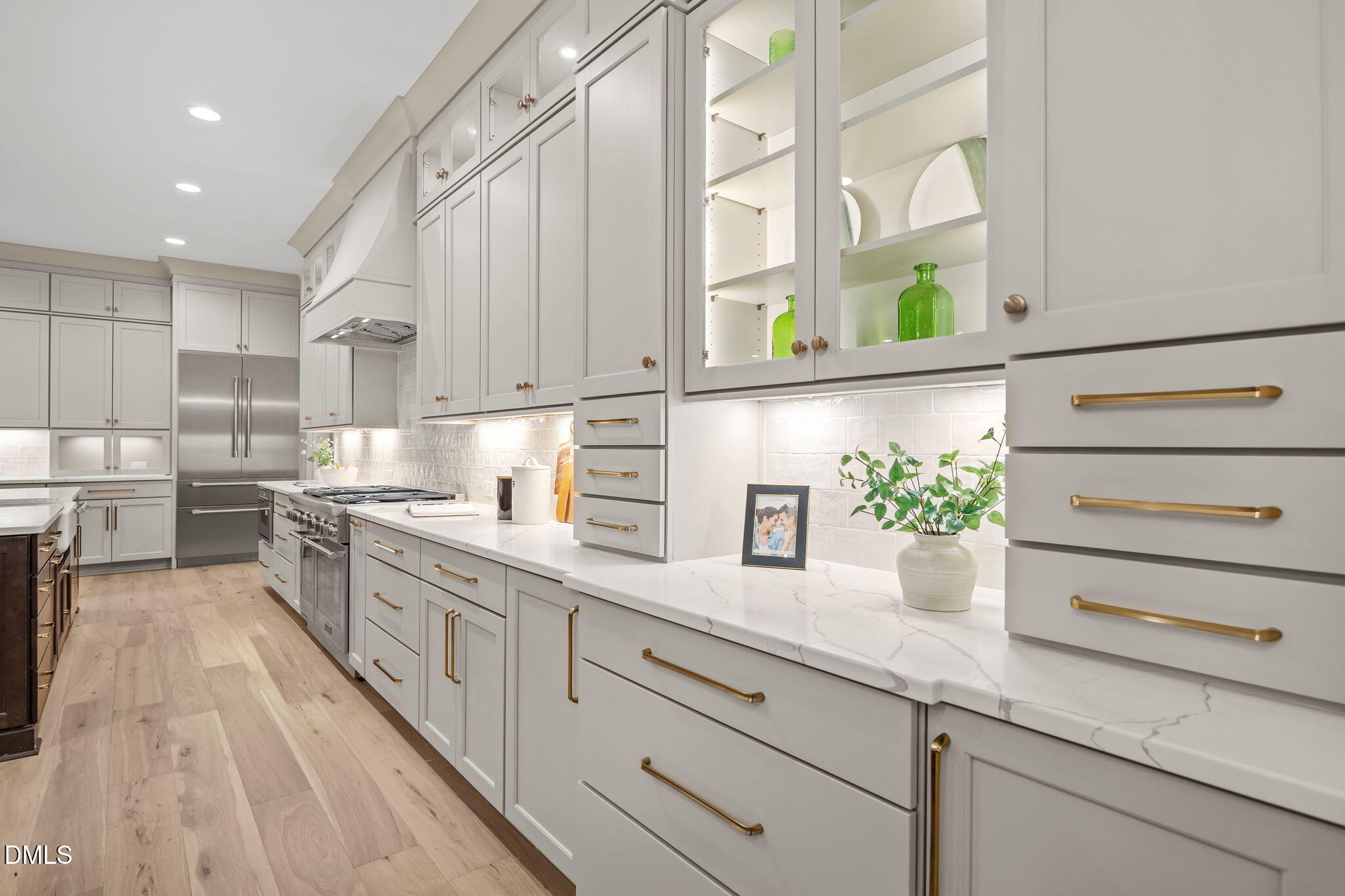 1318 Ivy Lane Raleigh, NC 27609 - Photo 12 of 61 a kitchen with granite countertop kitchen island white cabinets and white appliances