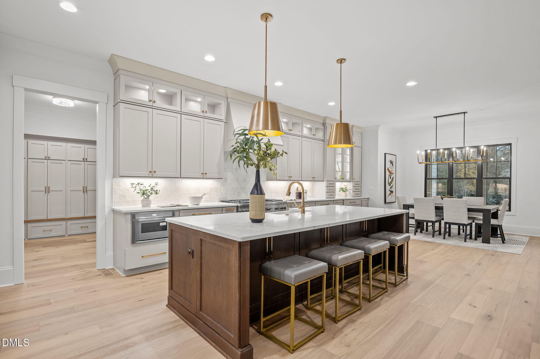 1318 Ivy Lane Raleigh, NC 27609 - Photo 14 of 61 a kitchen with kitchen island granite countertop a table chairs sink and cabinets