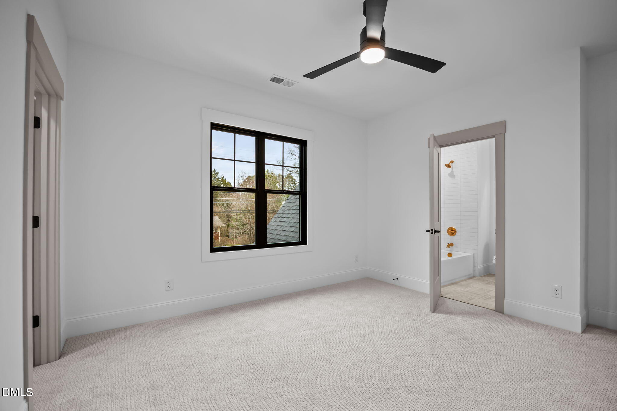 1318 Ivy Lane Raleigh, NC 27609 - Photo 28 of 61 an empty room with chandelier fan and windows