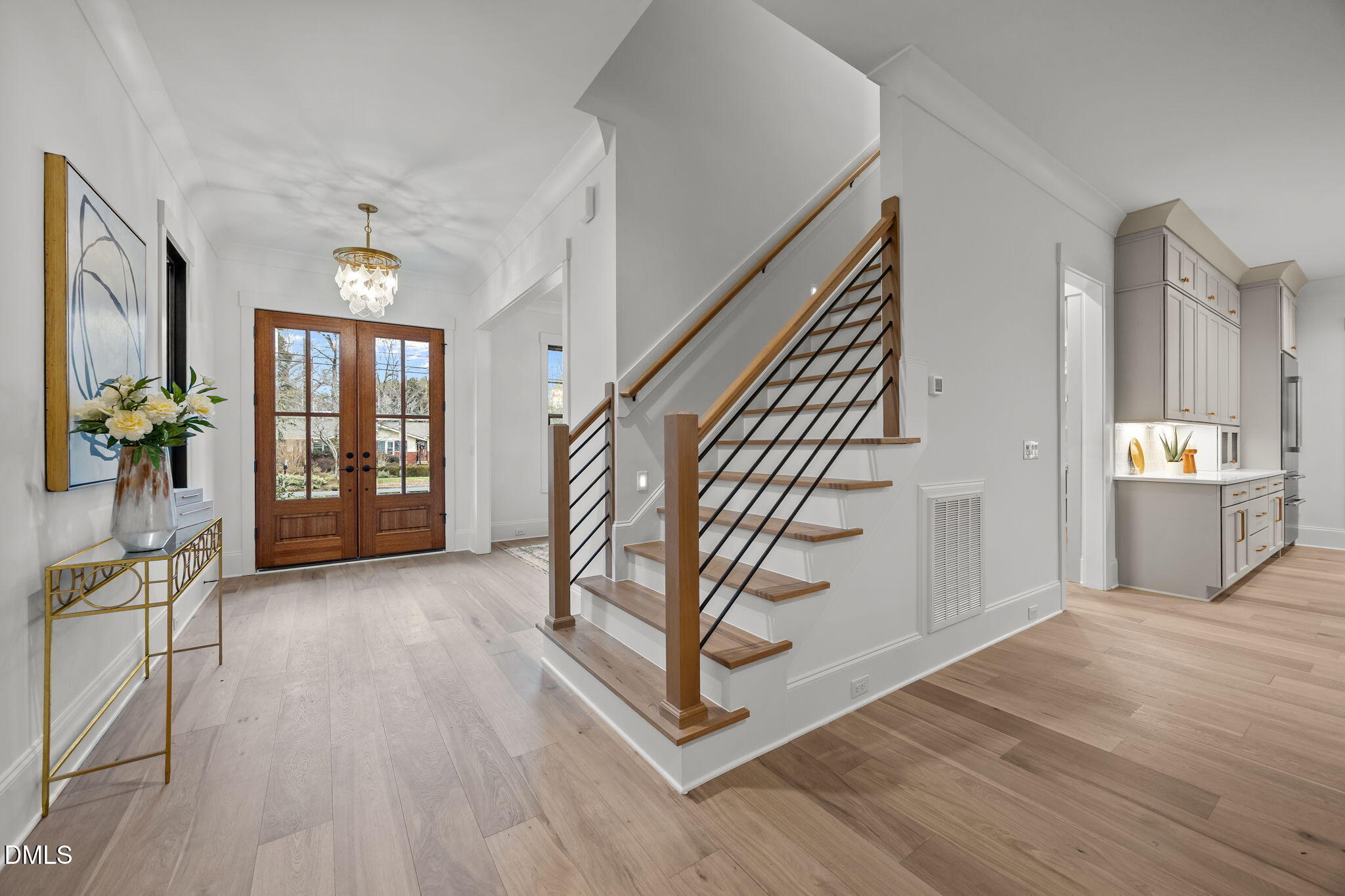 1318 Ivy Lane Raleigh, NC 27609 - Photo 4 of 61 a view of an entryway with wooden floor windows and a livingroom