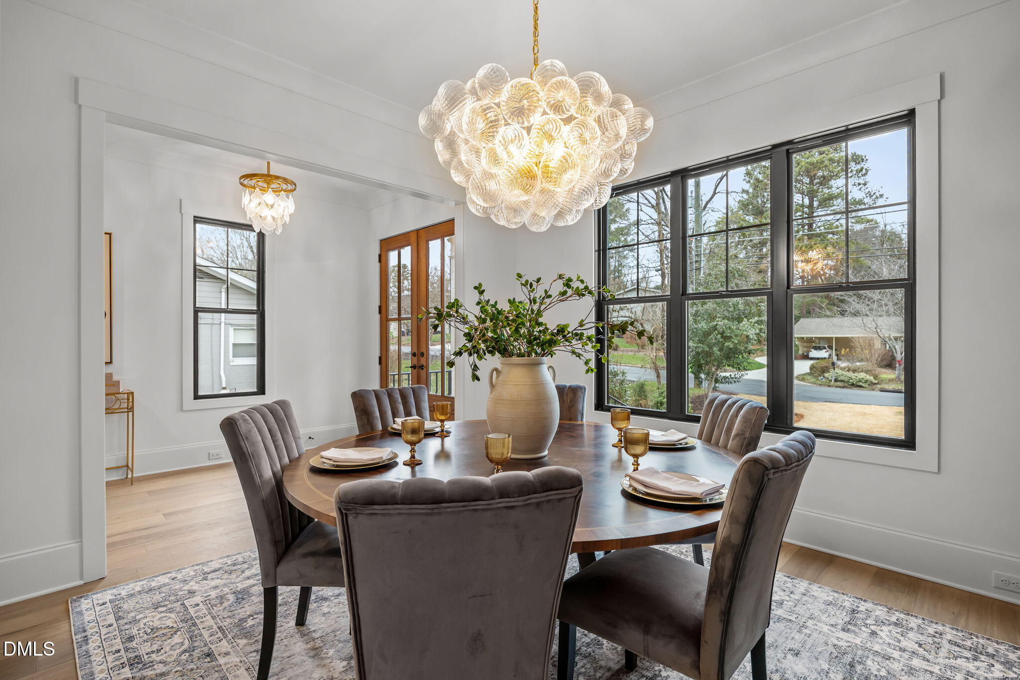 1318 Ivy Lane Raleigh, NC 27609 - Photo 6 of 61 a dining room with furniture a chandelier and wooden floor