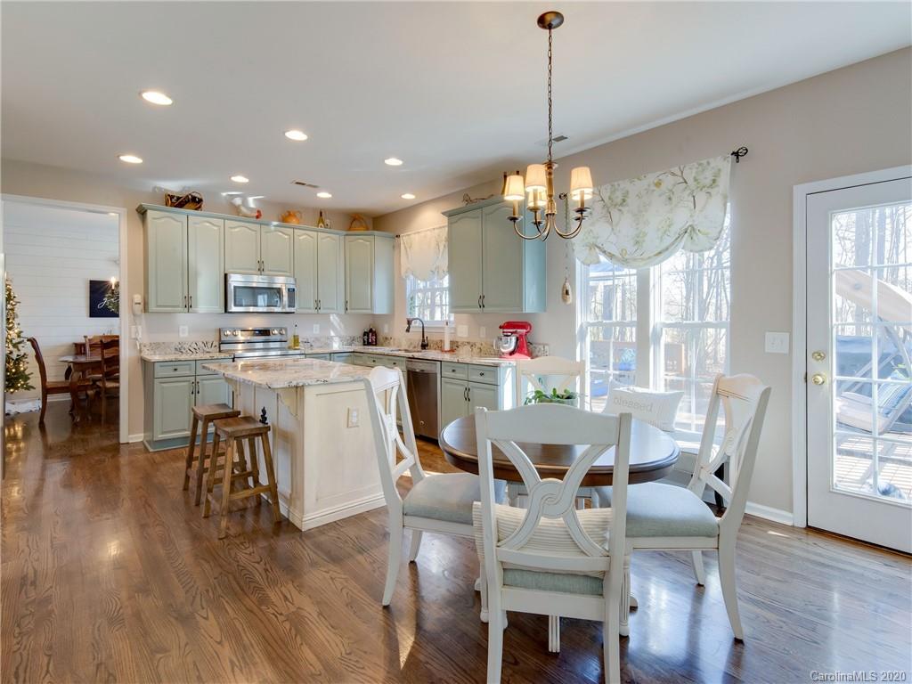 3028 Strawberry Road Matthews, NC 28104 - Photo 14 of 44 a view of a dining room and livingroom with furniture wooden floor a chandelier