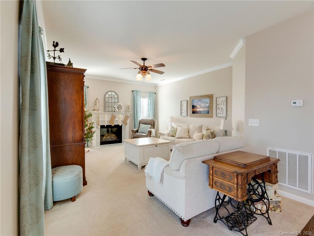 3028 Strawberry Road Matthews, NC 28104 - Photo 21 of 44 a living room with fireplace furniture and a chandelier
